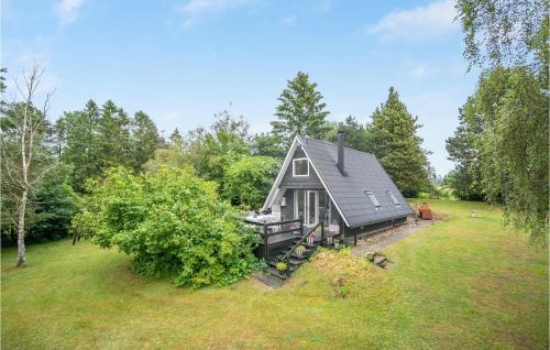 a home in the middle of a yard with a house at Holiday Home Pukkelvej Ebeltoft V in Ebeltoft