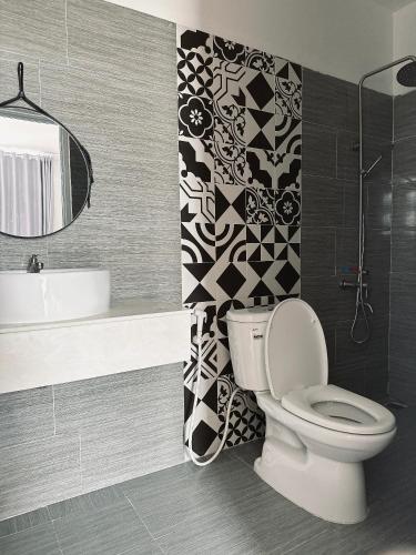 a bathroom with a toilet and a sink at Sele House in Ha Tien