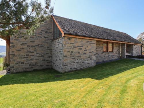 a brick house with a large lawn in front of it at Balvaig in Pitlochry