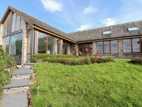 an exterior view of a house with glass windows at Balvaig in Pitlochry