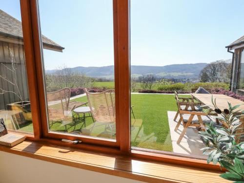 a window view of a patio with a table and chairs at Balvaig in Pitlochry