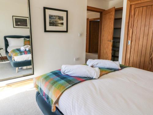 a bedroom with a bed and a large mirror at Balvaig in Pitlochry