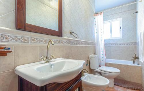 a bathroom with a sink and a toilet at Awesome Home In Torrox With 3 Bedrooms, Wifi And Outdoor Swimming Pool in Torrox