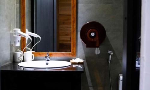 a bathroom with a sink and a mirror at Lemon House in Quy Nhon