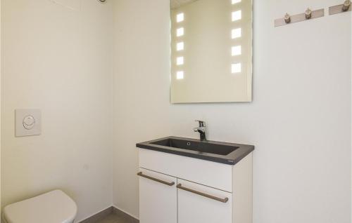 a bathroom with a sink and a toilet at Holiday Home Keld Hansensvej Ringkøbing Iii in Søndervig