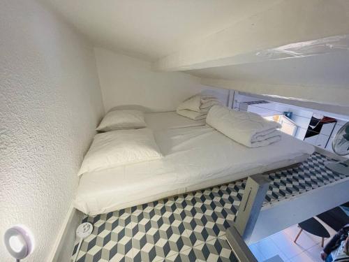 - un petit lit dans une petite pièce dans l'établissement Studio moderne proche plage, climatisé, terrasse, parking inclus - Cap d'Agde - FR-1-723-98, au Cap d'Agde