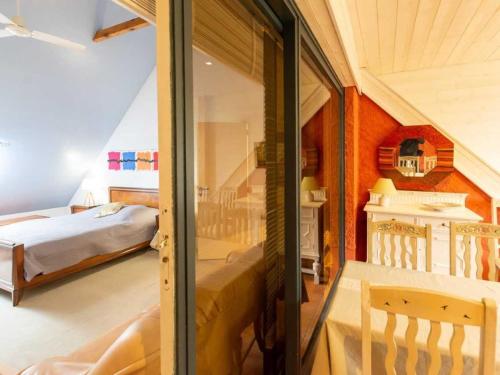a room with two beds and a glass door at Maison familiale au cœur d'une forêt centenaire avec piscine et proche du Zoo de la Flèche - FR-1-410-395 in Dureil