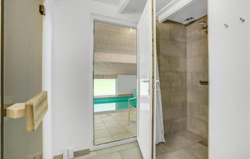 a bathroom with a shower and a mirror at Stunning Home In Vggerlse With Sauna, Wifi And Indoor Swimming Pool in Bøtø By