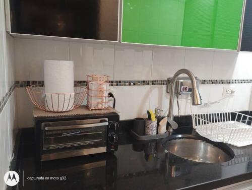 a kitchen counter top with a sink and a sink at Apartamento sector exclusivo acogedor in Bogotá