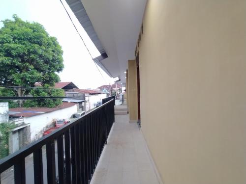 a hallway of a building with a balcony at RedDoorz near Prawirotaman Yogyakarta in Yogyakarta