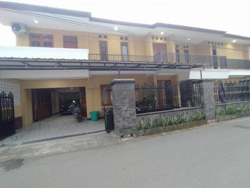 a house with a balcony and a driveway at RedDoorz near Prawirotaman Yogyakarta in Yogyakarta