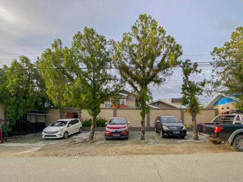 a group of cars parked in a parking lot with trees at Urbanview Hotel ME Jayapura in Jayapura