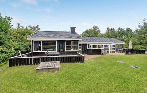 a house with a large yard with a house at Cozy Home In Jerup With Kitchen in Jerup