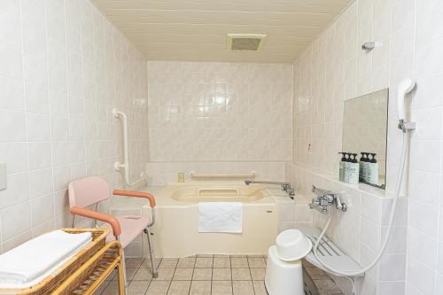 a bathroom with a bath tub and a sink at Forest Hongo by unito in Tokyo