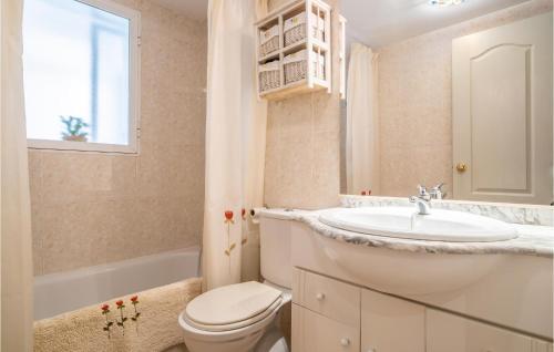 a white bathroom with a sink and a toilet at Nice Apartment In La Cala Del Moral With Kitchen in Cala del Moral