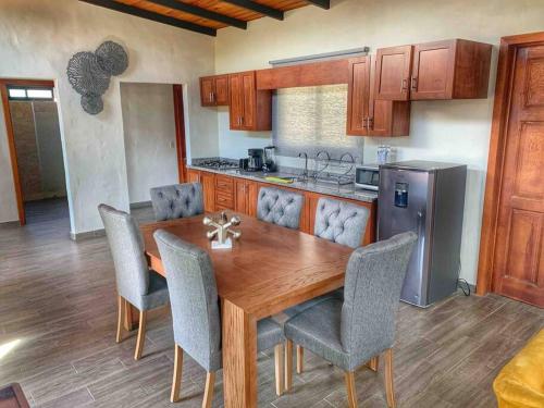 a kitchen with a wooden table and chairs at Cabaña 07 in Mazamitla