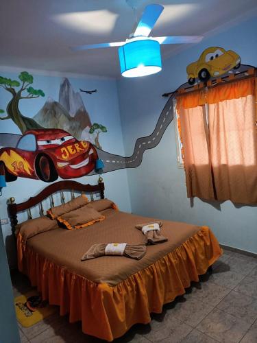 a bedroom with a bed with a car on the wall at Ashpa newen in Chilecito