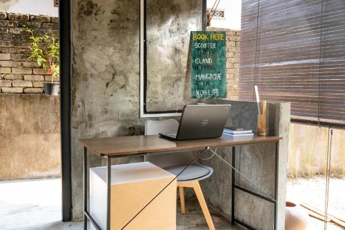 an office with a desk with a laptop on it at Bunga Hostel Female Dorm in Pantai Cenang