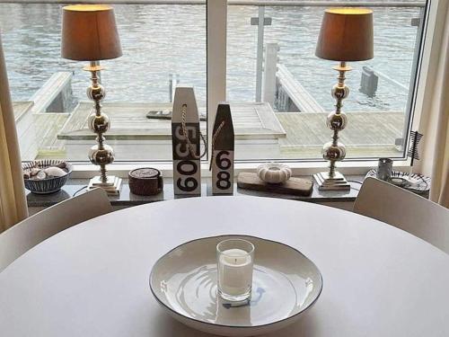 a glass of milk sitting on a white table with a window at 4 person holiday home in Smögen-By Traum in Smögen