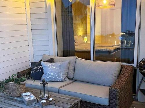 a couch sitting on a porch with pillows on it at 4 person holiday home in Smögen-By Traum in Smögen