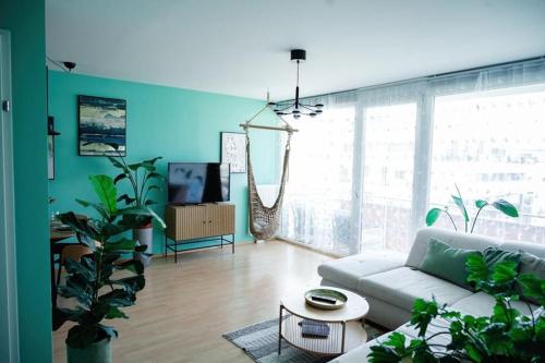 a living room with a couch and a table at Boho-Chic-Wohnung Neusiedl in Neusiedl am See