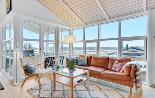 a living room with a couch and windows at Søglimt in Hejls