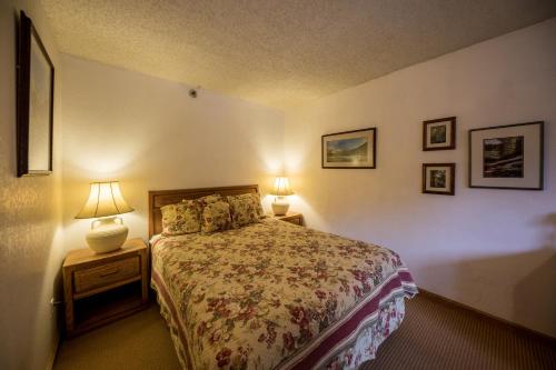 a bedroom with a bed and two lamps on tables at Iron Horse Building D Unit 4104 in Winter Park