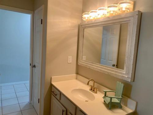a bathroom with a sink and a mirror at 10 H Two Bedroom Condo in Destin