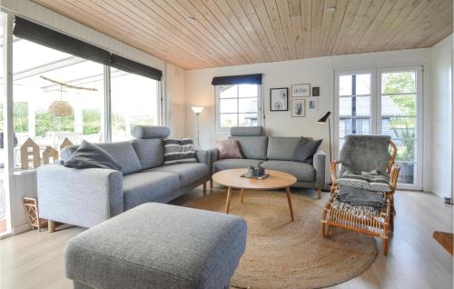 a living room with a couch and a table at Hygihytten in Hemmet