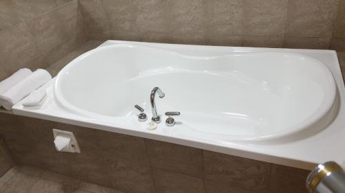 a bathroom with a white sink and a toilet at 97 Motel Moray in Dunedin