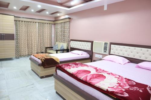 a bedroom with two beds in a room at STAYMAKER Hotel Suraj - Only Indian Citizens Allowed in Haldia