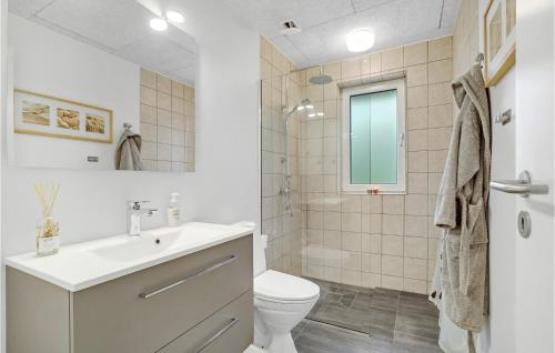 a white bathroom with a sink and a toilet at Stunning Home In Spttrup With 4 Bedrooms in Spottrup