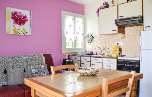 a kitchen with a wooden table in a room at Stunning Home In St, Bressou With 2 Bedrooms in Saint-Bressou