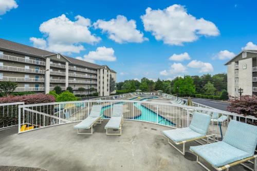 a balcony with chairs and a swimming pool at Lazy Bear Whispering Pines 111 in Pigeon Forge