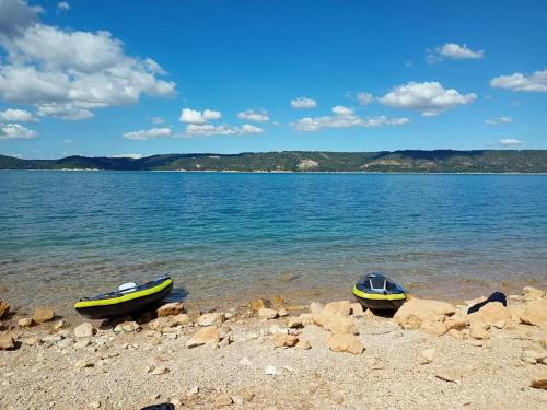 two boats sitting on the shore of a body of water at Villa Castellane in Bauduen