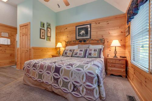 a bedroom with a large bed and wooden walls at Americana, 2 Bedrooms, Sleeps 6, View, Pool Access, Hot Tub, Fireplace in Gatlinburg