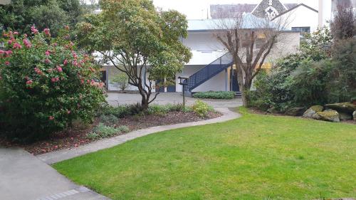 a garden with a path leading to a house at 97 Motel Moray in Dunedin