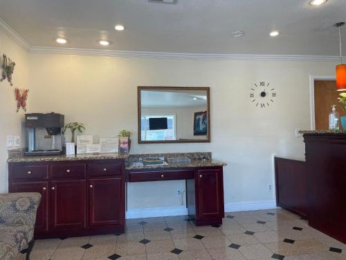 a bathroom with a sink and a mirror on the wall at Holiday Motel Oakdale in Oakdale