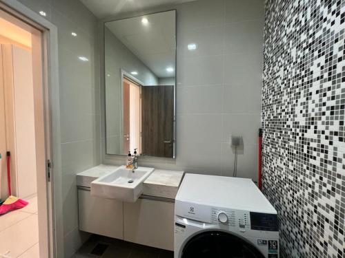 a bathroom with a sink and a washing machine at Kuala Lumpur near KLCC Soho Suite in Kuala Lumpur