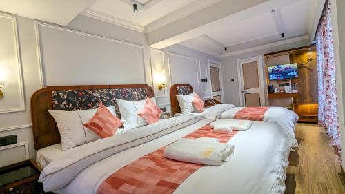 ダージリンにあるHotel Sonar Bangla Darjeelingのベッドルーム1室(枕付きのベッド2台付)