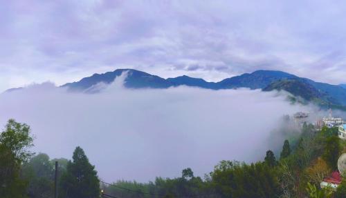 a view of a foggy valley with mountains in the background at Gegbyan in Ch'ia-la