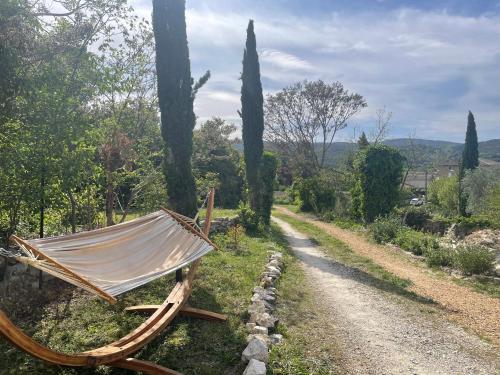 a hammock sitting on the side of a road at Gîte passiflore in Frigoulet