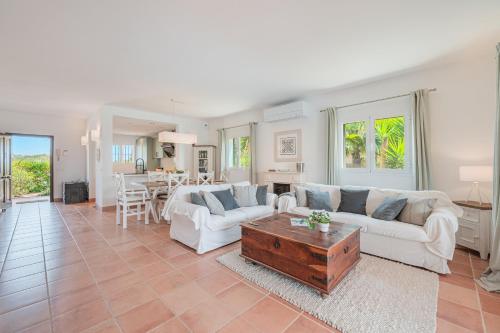 a living room with a couch and a table at Casa Mayor Strand Es Trenc 5 min in Sa Ràpita