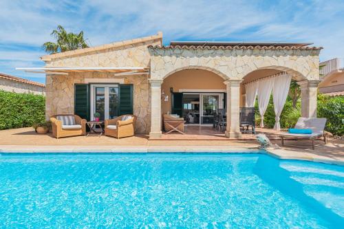 a villa with a swimming pool and a patio at Casa Mayor Strand Es Trenc 5 min in Sa Ràpita