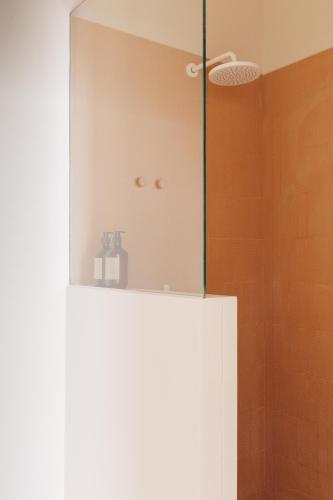 a bathroom with a white cabinet with a shelf at Plácido y Grata in Seville
