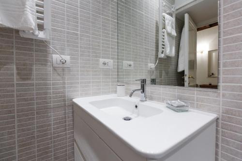 a white bathroom with a sink and a mirror at NAVONA, Old Rome Lodge in Rome