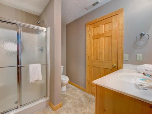 a bathroom with a shower and a sink and a toilet at Bear’s Corner, 3 Bedrooms, WiFi, Pool Table, Hot Tub, WiFi, Sleeps 10 in Gatlinburg