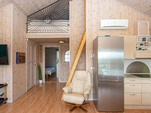 a kitchen with a chair and a refrigerator at 8 person holiday home in Struer-By Traum in Struer