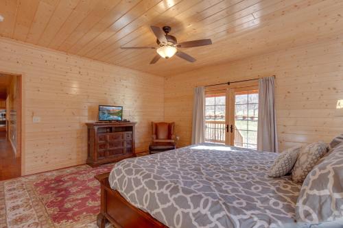 a bedroom with a bed and a ceiling fan at Orchard Hideaway in Cosby