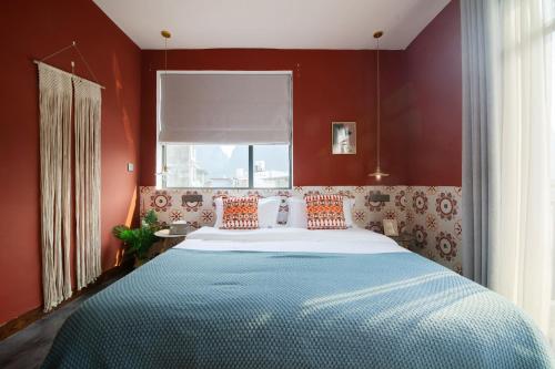 a bedroom with a large bed with red walls at Yangshuo Jing Yuan Inn Near The West Street in Yangshuo